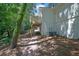 A backyard featuring a brick pathway, deck, and exterior of the home with AC units at 4999 Willow Creek Dr, Woodstock, GA 30188