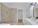 Stylish bathroom showcasing a tiled shower and a sleek vanity with stone countertops at 4999 Willow Creek Dr, Woodstock, GA 30188