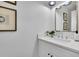 Well-lit bathroom with quartz countertops, framed mirror, and ample storage at 4999 Willow Creek Dr, Woodstock, GA 30188