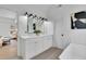Bathroom featuring double vanity, sleek fixtures, and modern artwork at 4999 Willow Creek Dr, Woodstock, GA 30188
