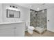 Bathroom featuring a walk-in shower with tiled walls and a modern vanity at 4999 Willow Creek Dr, Woodstock, GA 30188