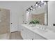 Bright bathroom featuring double vanity, sleek fixtures, and walk-in shower at 4999 Willow Creek Dr, Woodstock, GA 30188