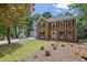 Charming two-story brick home with an attached two-car garage and traditional landscaping at 4999 Willow Creek Dr, Woodstock, GA 30188