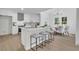 Beautiful kitchen with a large island, pendant lighting, and seating for three at 4999 Willow Creek Dr, Woodstock, GA 30188