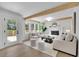 Bright and airy living room with a white fireplace, exposed wood beams, and modern, neutral decor at 4999 Willow Creek Dr, Woodstock, GA 30188