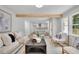 Open concept living room with hardwood floors and natural wood beams at 4999 Willow Creek Dr, Woodstock, GA 30188