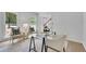 Stylish home office featuring a glass-topped desk, comfortable seating, and bright, natural light at 4999 Willow Creek Dr, Woodstock, GA 30188