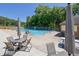A community pool with lounge chairs and shade umbrellas on a sunny day at 4999 Willow Creek Dr, Woodstock, GA 30188