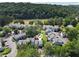 Aerial view of townhouses nestled by lush greenery and a river, showcasing a serene and picturesque community at 1027 Riverbend Club Se Dr, Atlanta, GA 30339