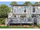 Backyard deck with table and chairs, a grill, and a lush lawn and greenery surrounding it at 1027 Riverbend Club Se Dr, Atlanta, GA 30339