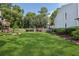 The backyard boasts a lush green lawn with mature trees and landscaping at 1027 Riverbend Club Se Dr, Atlanta, GA 30339