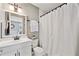 Bathroom featuring a white vanity, mirror, and shower with a white shower curtain at 1027 Riverbend Club Se Dr, Atlanta, GA 30339