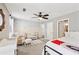 Bedroom features a crib, cozy chair and ceiling fan with a connecting bathroom at 1027 Riverbend Club Se Dr, Atlanta, GA 30339