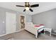 This bedroom features neutral walls and carpet, a ceiling fan, and a black metal bed frame at 1027 Riverbend Club Se Dr, Atlanta, GA 30339