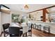 Cozy dining area with views of the outdoor deck, adjacent to a modern kitchen at 1027 Riverbend Club Se Dr, Atlanta, GA 30339