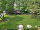 Fenced dog park with a lush green lawn, trees, and equipment creates a safe and enjoyable space for pets to play at 1027 Riverbend Club Se Dr, Atlanta, GA 30339