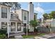 Charming two-story townhouse with grey siding, black trim, a chimney, and a well-manicured front yard at 1027 Riverbend Club Se Dr, Atlanta, GA 30339