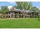 Stunning exterior showcasing lush green lawn, outdoor seating and manicured landscape at 1027 Riverbend Club Se Dr, Atlanta, GA 30339