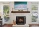 Close-up of a cozy fireplace with a decorative mantel, inset within a bright living area at 1027 Riverbend Club Se Dr, Atlanta, GA 30339