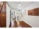 Bright hallway with wood floors, decorative wall art, and views of stairwell at 1027 Riverbend Club Se Dr, Atlanta, GA 30339