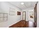 Hallway featuring rich wood floors, decorative mirrors, and a barn door entry at 1027 Riverbend Club Se Dr, Atlanta, GA 30339