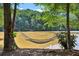 A serene riverside view with a hammock is surrounded by lush trees at 1027 Riverbend Club Se Dr, Atlanta, GA 30339