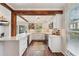 Well-lit kitchen featuring white cabinets, stainless steel appliances, and a marble countertop bar overlooking the dining area at 1027 Riverbend Club Se Dr, Atlanta, GA 30339