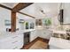 Modern kitchen with white cabinets, a marble countertop, a wine cooler, and stainless steel appliances at 1027 Riverbend Club Se Dr, Atlanta, GA 30339