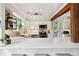 Contemporary kitchen with white cabinets, stainless steel appliances, marble countertops, and stylish shelving at 1027 Riverbend Club Se Dr, Atlanta, GA 30339