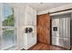 Bright kitchen featuring stainless steel refrigerator, white cabinets and a rustic barn door at 1027 Riverbend Club Se Dr, Atlanta, GA 30339