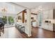 Bright, open kitchen with white cabinets, a marble countertop bar, modern appliances, and wood beam details at 1027 Riverbend Club Se Dr, Atlanta, GA 30339