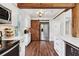Charming kitchen boasts modern appliances, white cabinets, marble countertops, and a unique barn door at 1027 Riverbend Club Se Dr, Atlanta, GA 30339