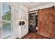 Convenient laundry room featuring a stacked washer/dryer unit and custom barn door entry at 1027 Riverbend Club Se Dr, Atlanta, GA 30339
