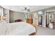 Main bedroom with connected bathroom, television, ceiling fan and neutral tones at 1027 Riverbend Club Se Dr, Atlanta, GA 30339