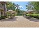 Expansive brick patio featuring outdoor seating areas with umbrellas and manicured landscaping at 1027 Riverbend Club Se Dr, Atlanta, GA 30339