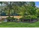 A serene river view with green grass, trees, a fence, and shrubs makes an enchanting outdoor space to be enjoyed at 1027 Riverbend Club Se Dr, Atlanta, GA 30339