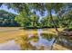 Trees frame a lovely river view with a clear blue sky reflected in the smooth water at 1027 Riverbend Club Se Dr, Atlanta, GA 30339