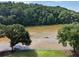 Peaceful water view surrounded by mature trees and a lush landscape at 1027 Riverbend Club Se Dr, Atlanta, GA 30339