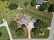Aerial view of the home, with a spacious lawn, mature trees, long driveway, and well-manicured landscaping at 105 Whippoorwill Way, Fayetteville, GA 30215