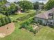 Picture of well-maintained backyard, complete with a garden and lush green lawn, surrounded by mature trees at 105 Whippoorwill Way, Fayetteville, GA 30215