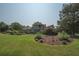 Picturesque backyard showcasing a well-kept lawn, mature trees, and manicured landscaping for peaceful relaxation at 105 Whippoorwill Way, Fayetteville, GA 30215