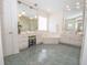 Bathroom featuring a jacuzzi tub, vanity area with mirror, stool, and tiled floors at 105 Whippoorwill Way, Fayetteville, GA 30215