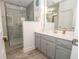Modern bathroom featuring a glass-enclosed shower and gray vanity with storage at 105 Whippoorwill Way, Fayetteville, GA 30215