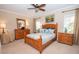 Cozy bedroom with wood furniture, ceiling fan, and natural light from the windows at 105 Whippoorwill Way, Fayetteville, GA 30215