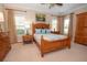 Charming bedroom with wood furniture, ceiling fan, and natural light at 105 Whippoorwill Way, Fayetteville, GA 30215