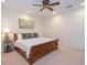 Bright bedroom with a light carpet, cherry wood bed, ceiling fan and decorative wall art at 105 Whippoorwill Way, Fayetteville, GA 30215