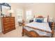 Charming bedroom with wood bed frame, dresser, and blue accents at 105 Whippoorwill Way, Fayetteville, GA 30215
