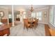 Elegant dining room with a large wooden table, chandelier, and open layout perfect for entertaining at 105 Whippoorwill Way, Fayetteville, GA 30215