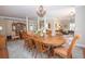 Spacious dining area showcasing a large wooden table, chandelier, and seamless flow into the adjacent living space at 105 Whippoorwill Way, Fayetteville, GA 30215