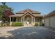Charming home with a welcoming front porch and well-maintained landscaping leading to a three-car garage at 105 Whippoorwill Way, Fayetteville, GA 30215